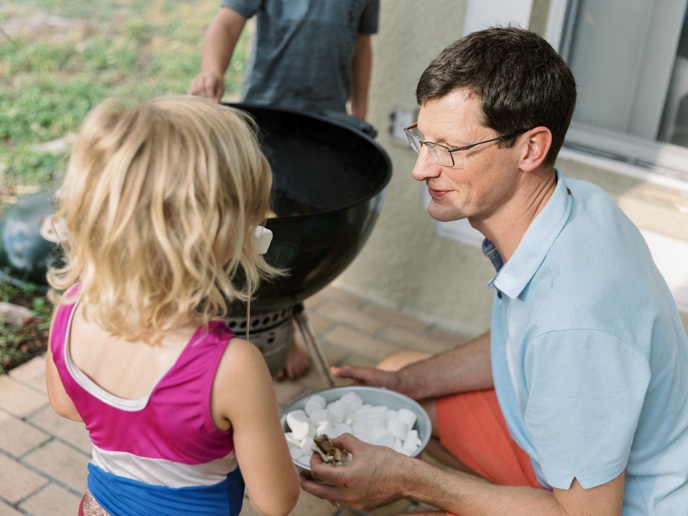 Man with marshmallows at a community group cookout