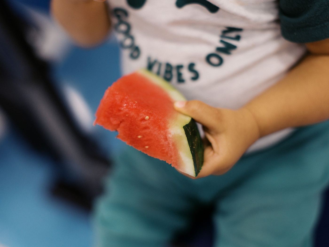 Close-up of a child holding a slice of watermelon at the church fellowship meal