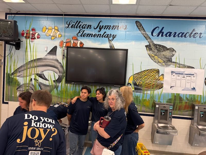 Hope Family Church volunteers in matching navy shirts gathered at Lillian Symmes Elementary School